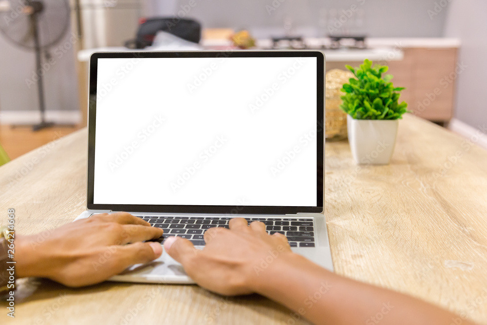 Wall mural mockup image of a businessman using laptop with blank white desktop screen working in home- image