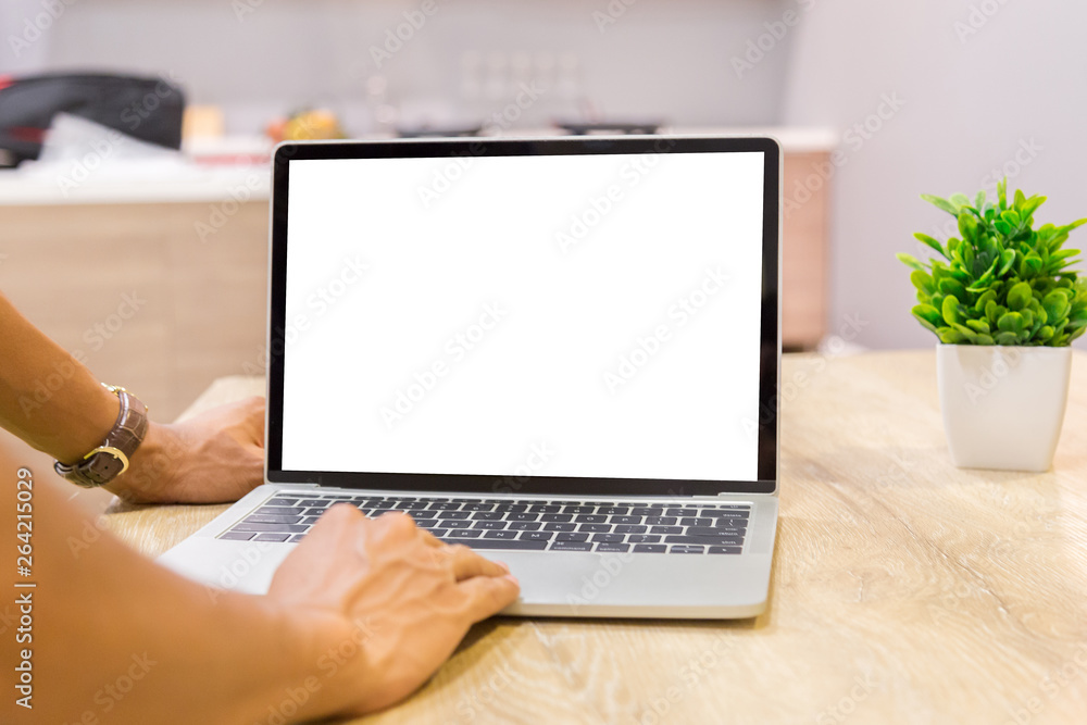 Poster mockup image of a businessman using laptop with blank white desktop screen working in home- image