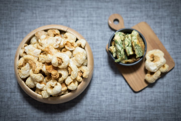 Crispy deep fried pork skin in wooden bowl