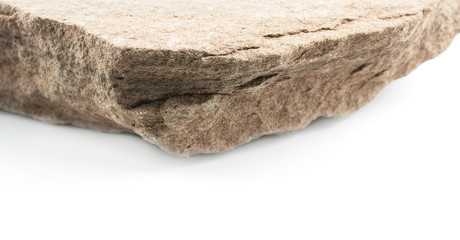 Rock empty table front of blurred white background.