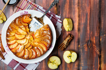 apple tart with caramel and cinnamon on wooden table