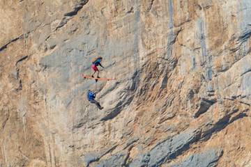 two people surfing on a line during a base jump session, Auvergne-Rhône-Alpes,...