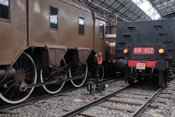 Fototapeta na wymiar Old train station with Vintage black steam locomotive.