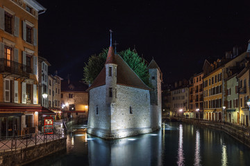 The night view of medieval insular palace Palais de l'Ile jail in Annecy city, France