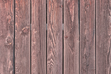 Naklejka premium Fence of vertical brown boards. Background with texture of old wood. Photo for layouts.