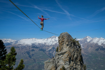 one woman walking on a highline in the French Alps, Auvergne-Rhône-Alpes, Bourg-Saint-Maurice,...