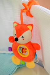 Plush fox figurine with inner ring and plastic wheels.