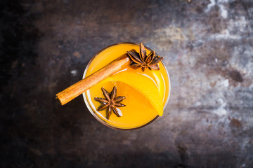 Orange cocktail with spices. Selective focus. Shallow depth of field.