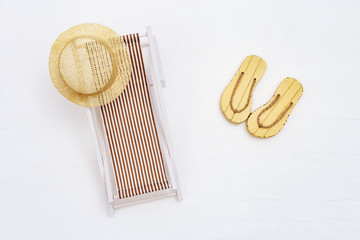 Sunbed and summer slippers on white sand. Summer vacation concept background. Relax on beach.