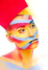 woman with creative geometry make up, red, yellow, blue closeup smiling colored, bright concept