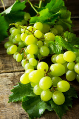 Ripe grapes on rustic wooden table. The concept of nutrition health, wine concept.