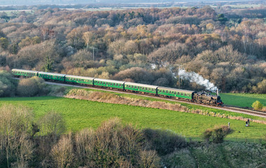 Naklejka premium Steam Steam Train Aerial View Moving Through the Forest Woodland