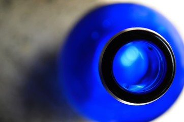 A blue glass bottle glowing in the sun light