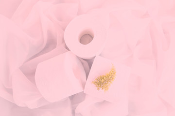 Fototapeta na wymiar Slightly hazed white toilet paper rolls on drapery cloth. Top view, Closeup. Copy space. Pink toned foggy background.