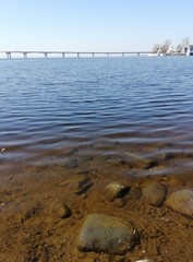 sea stones under water and bridge  