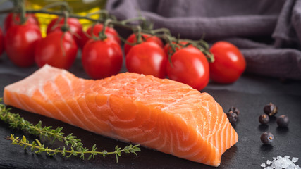 Raw salmon fillet with rosemary and tomatoes