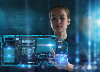 The concept of business, technology, the Internet and the network. A young entrepreneur working on a virtual screen of the future and sees the inscription: Implementation