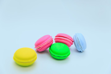 macaroonsMulticolored macaroon cakes on a blue background. Imitation Cakes