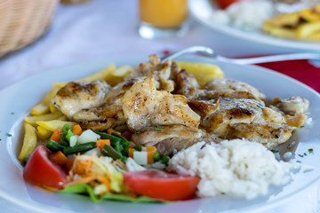 Grilled chicken breast, French fries and vegetables