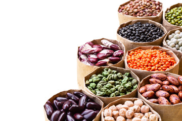 Various assortment set of indian legumes in paper sack bags isolated on white background.