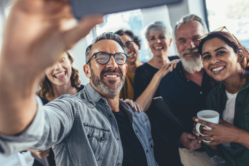 Group selfie in office