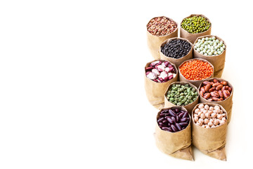 Various assortment set of indian legumes in paper sack bags isolated on white background.