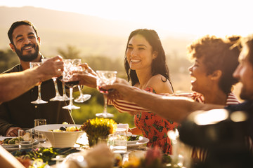 Group of friends making a toast at party