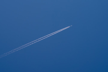Airliner contrail in perfect blue sky