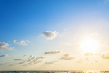 Obraz premium Beautiful early morning sunrise over the sea the horizon,blue sky background texture with white clouds sunset.