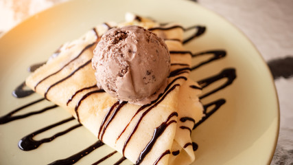 Cool crepes In the dish topped with chocolate and ice cream.