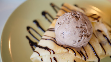Cool crepes In the dish topped with chocolate and ice cream.