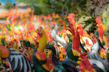 Colorful of a many cock statues in the temple of Thailand.