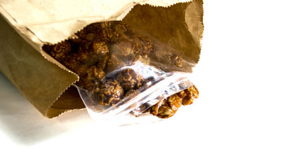 Chocolate covered popcorn in a clear plastic bag.