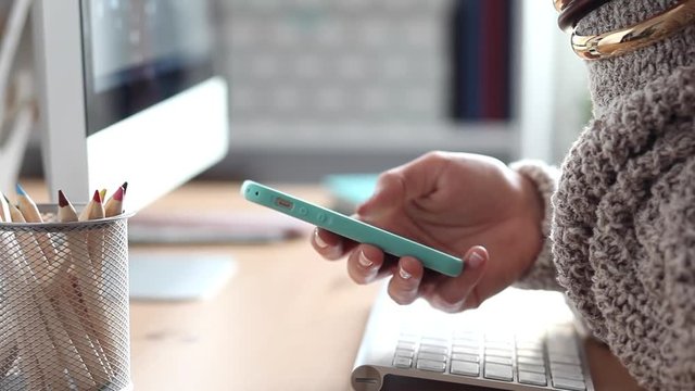 Young Woman Scrolling and Texting Using her Smartphone
