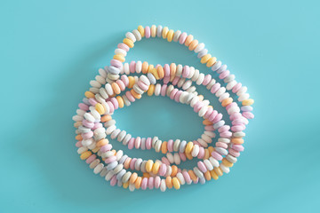 Beads and bracelets of sweets  candy on a turquoise background