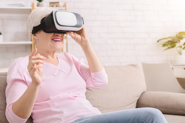 Senior woman watching video via vr glasses