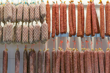 Many dried sausages in a butcher shop