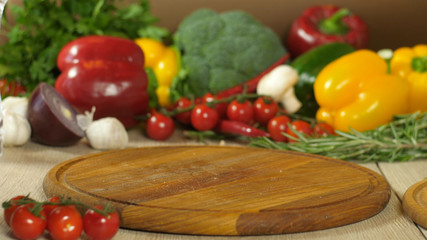 a background of pepper tomatoes garlic mushrooms vegetables on a wooden board