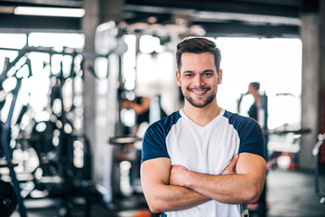 Fototapeta na wymiar Portrait of a personal trainer in sportswear at the fitness center or gym.