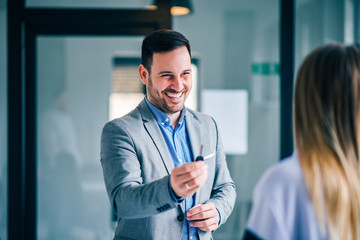 Human resources officer giving keys to an employee.