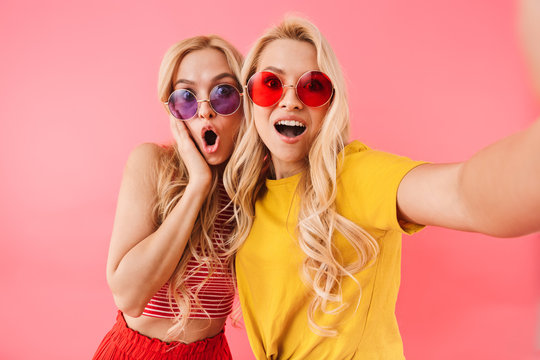 Funny blonde twins in sunglasses making selfie