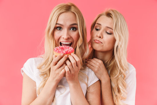 Image of Cheerful blonde woman eating donut