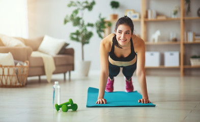 young woman doing fitness and sports at home