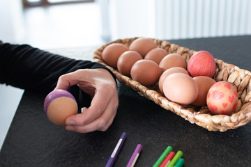 Eggs decoration, children is coloring an ester egg. Coloring eggs with pastel creativity activities...