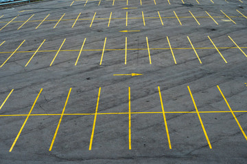 The marking lines in the parking lot with yellow paint on asphalt © Alex Sipeta
