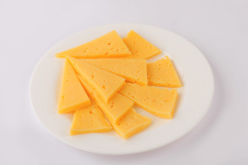 Cheese slice isolated on gray background cutout on a plate