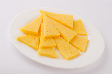Cheese slice isolated on gray background cutout on a plate