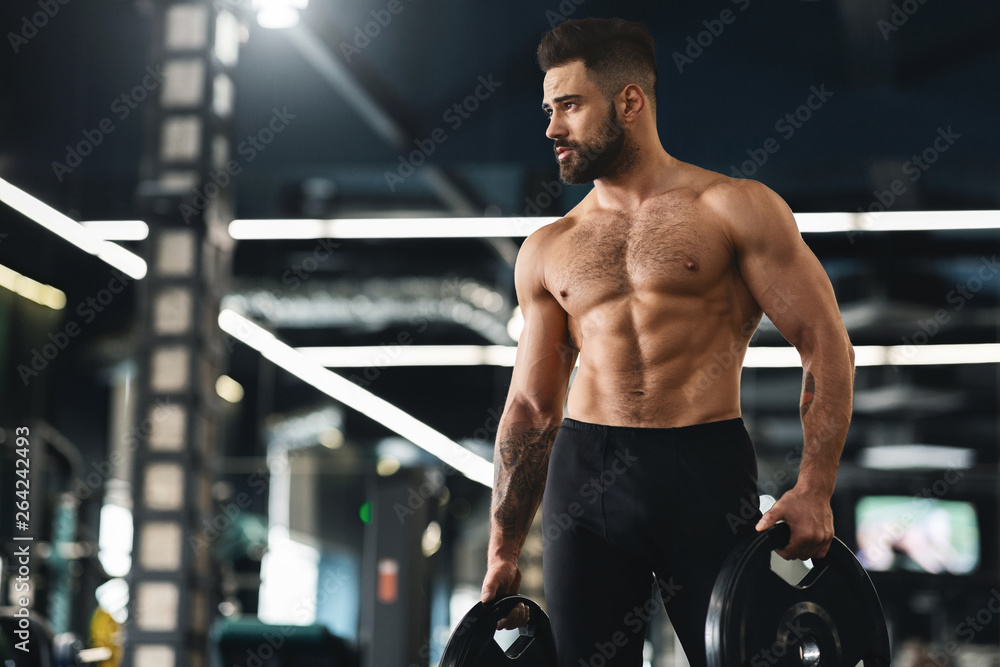 Poster Young muscular athlete exercising with barbell weights