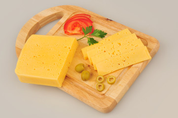 Cheese slice, parsley, tomatoes slice, isolated on gray background cutout on cutting board
