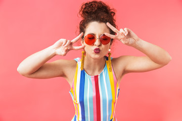 Joyful pretty redhead woman wearing in dress and sunglasses